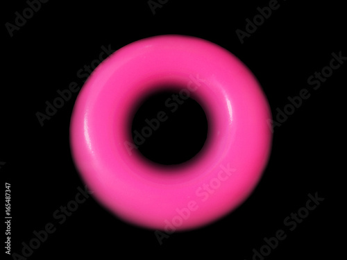 Plastic pink circle on black background