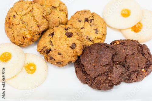 Top view of a plate of oatmeal chocolate  shortbread cookies on a white background