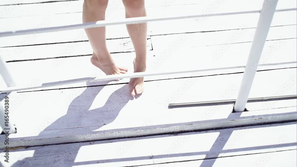 Young girl walking along boardwalk