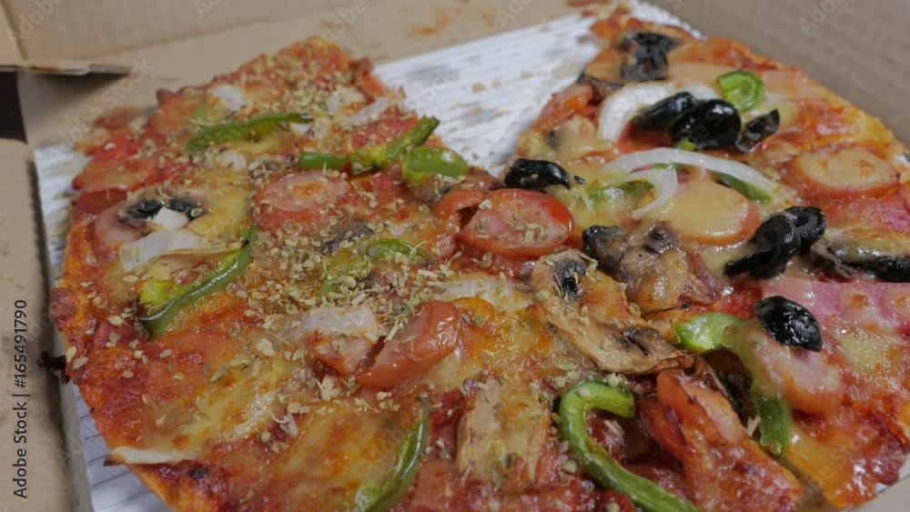 testy and delicious Italian Pizza with ham, pepper and olives in delivery box. testy and delicious Italian Pizza with ham, pepper and olives in delivery box.