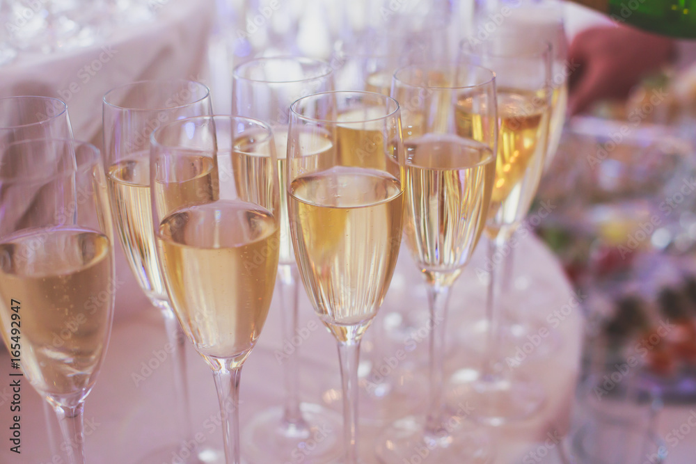 Line of different colored alcohol cocktails on a decorated catering banquet table on a party Line of different colored alcohol cocktails on a decorated catering banquet table on a party