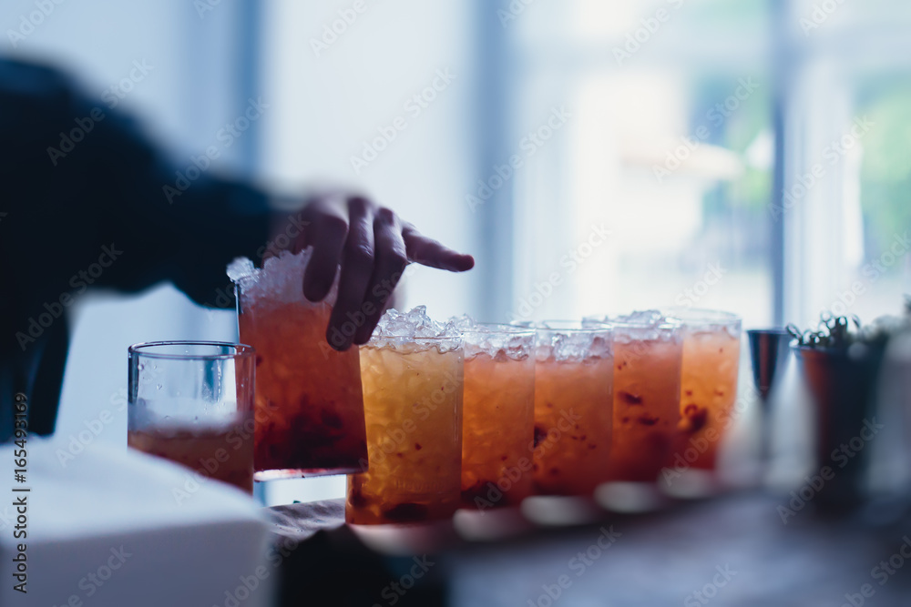 Line of different colored alcohol cocktails on a decorated catering banquet table on a party Line of different colored alcohol cocktails on a decorated catering banquet table on a party