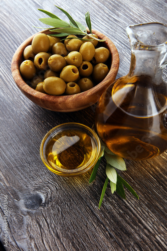 Fototapeta Naklejka Na Ścianę i Meble -  Bottle virgin olive oil and oil in a bowl with some olives