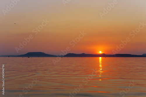 Sunset wallpaper of Lake Balaton with Badacsony mountains in the Bakcground  in Hungary