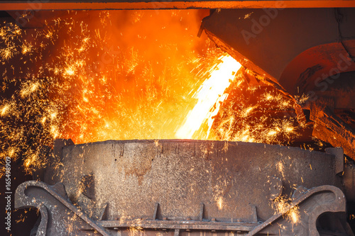 Fototapeta Liquid metal from blast furnace in the steel plant,industry landscape