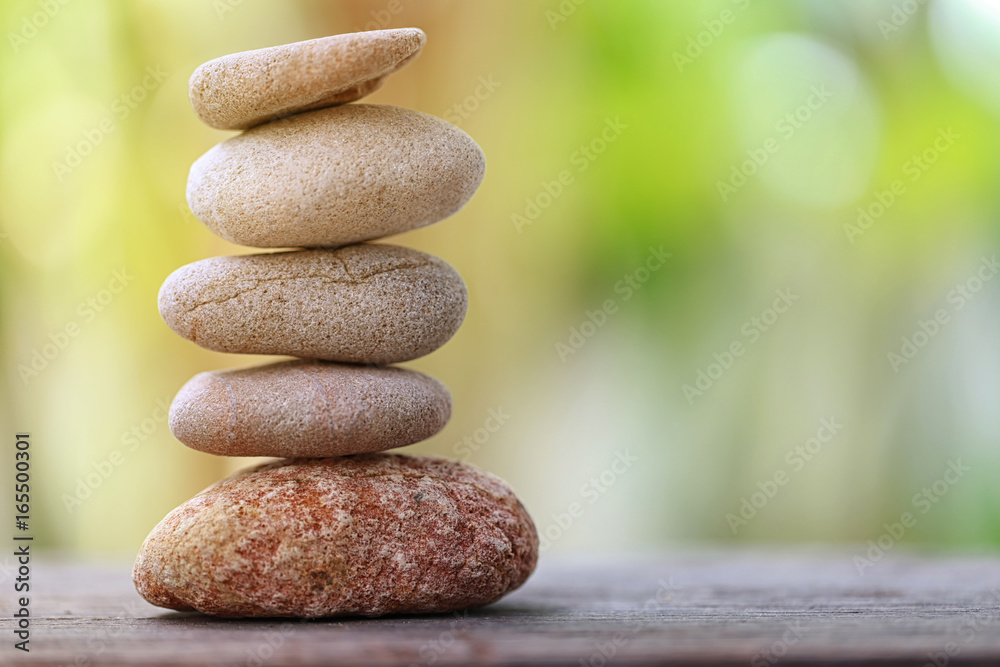 Balance Stone on wooden floor and soft sunlight in the garden.