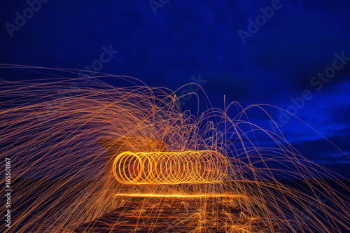 Showers of hot glowing sparks from spinning steel wool on the Wood bridge