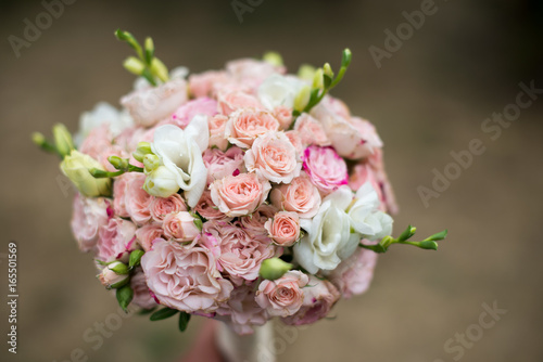 pink and white wedding bouquet on a blurred background © Alex