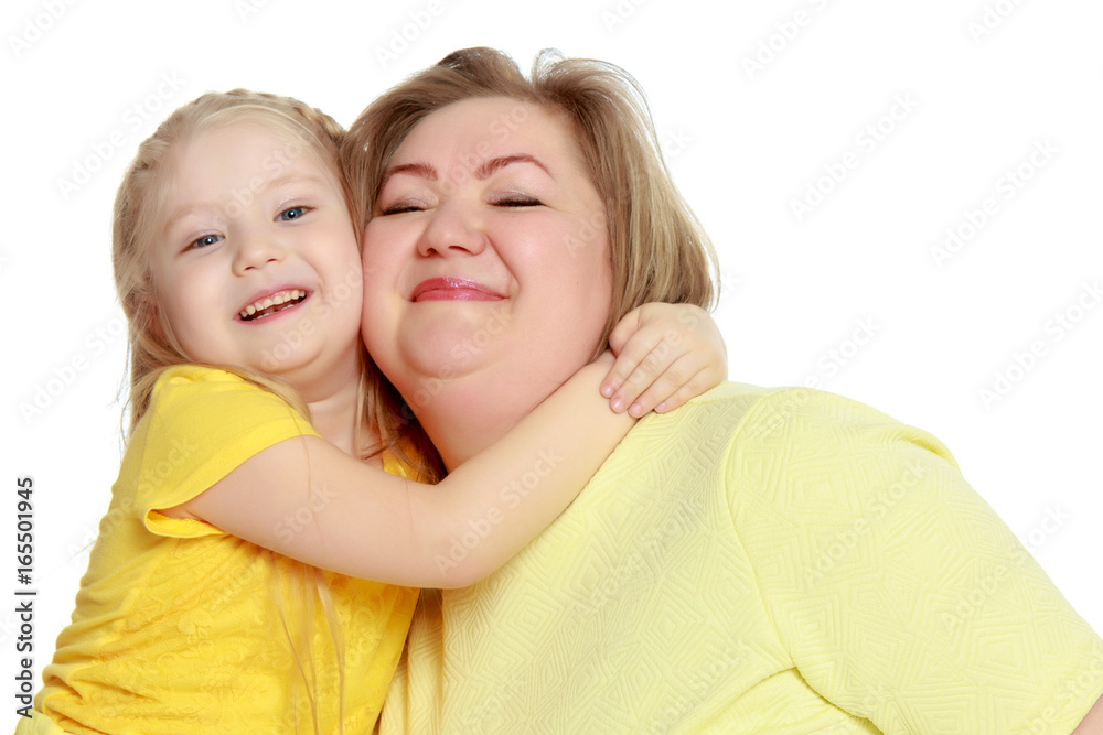A happy mother hugs her beloved daughter. A happy mother hugs her beloved daughter.