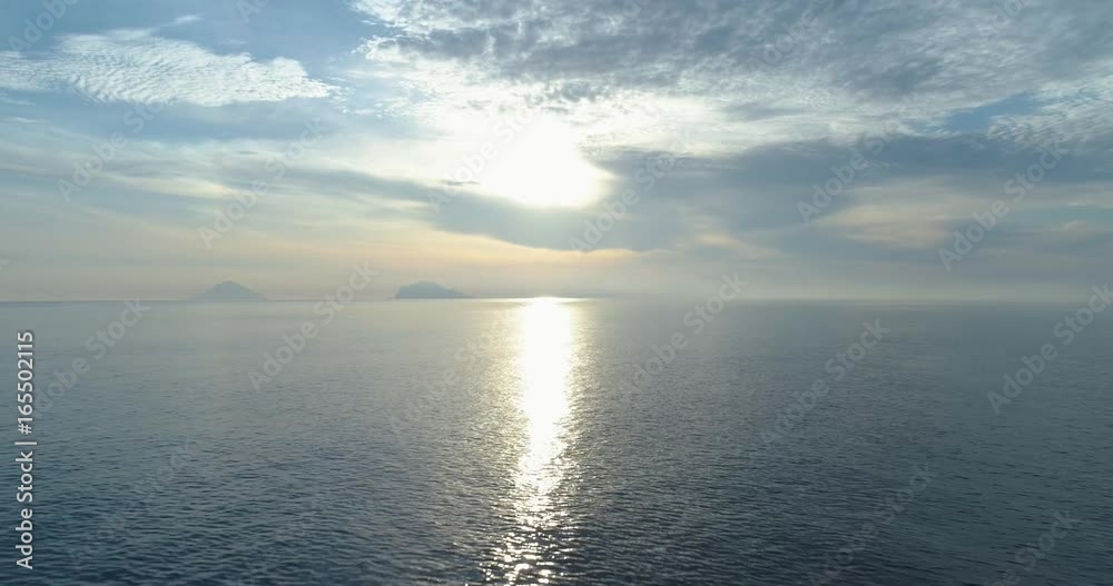 moving backward aerial view of mediterranean sea shore beach in Salina with far Stromboli volcano.Nature outdoors travel establisher,Italy,Sicily Eolian Island.Summer.4k drone establishing video moving backward aerial view of mediterranean sea shore beach in Salina with far Stromboli volcano.Nature outdoors travel establisher,Italy,Sicily Eolian Island.Summer.4k drone establishing video