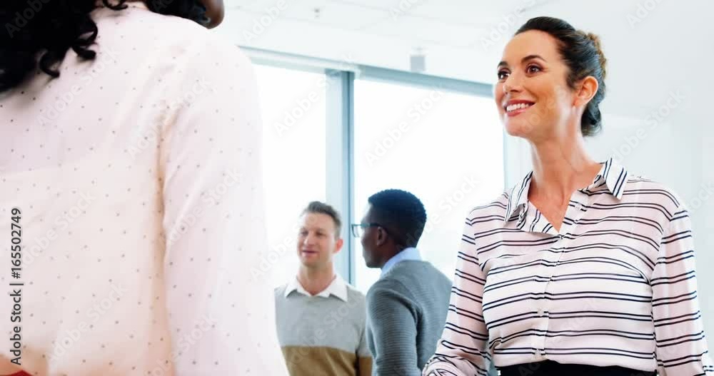 Executives shaking hands in office Executives shaking hands in office
