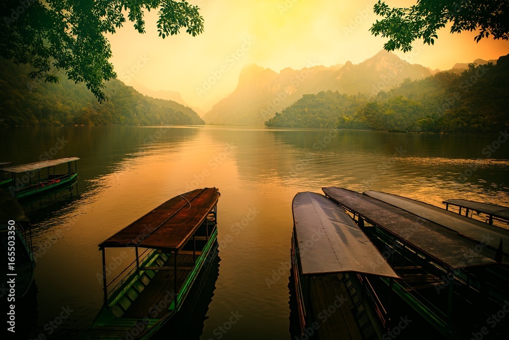 Fototapeta premium Ba Be lake, Bac Kan province, Vietnam - April 4, 2017 : tourists on the boat are going to enjoy and explore Ba Be lake. Stunning scenery of Ba Be Lake in Bac Kan Province, Vietnam