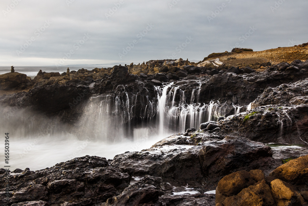 Water flow after ocean wave splashes against rocks Yachats Oregon Coast Water flow after ocean wave splashes against rocks Yachats Oregon Coast