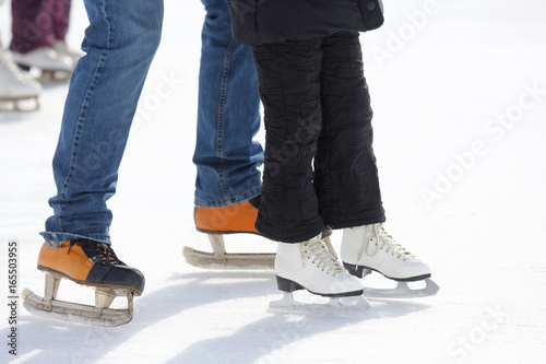 feet skating on the ice rink