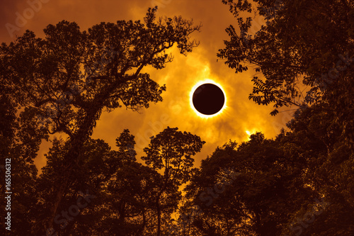 Scientific natural phenomenon. Total solar eclipse with diamond ring effect glowing on sky.