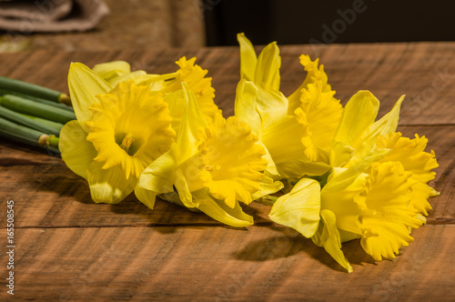 Yellow dafodills on wooden table