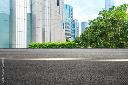 empty asphalt road and modern buildings in shanghai china.