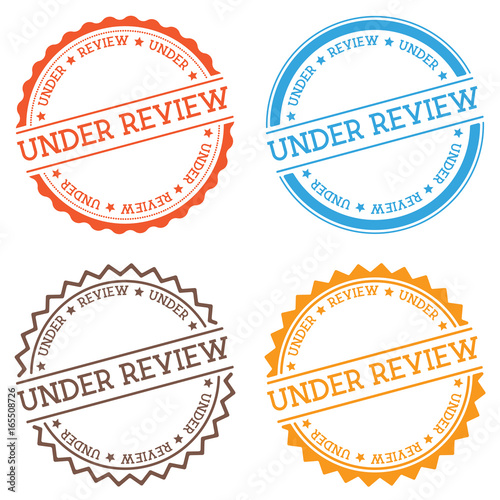Under review badge isolated on white background. Flat style round label with text. Circular emblem vector illustration.