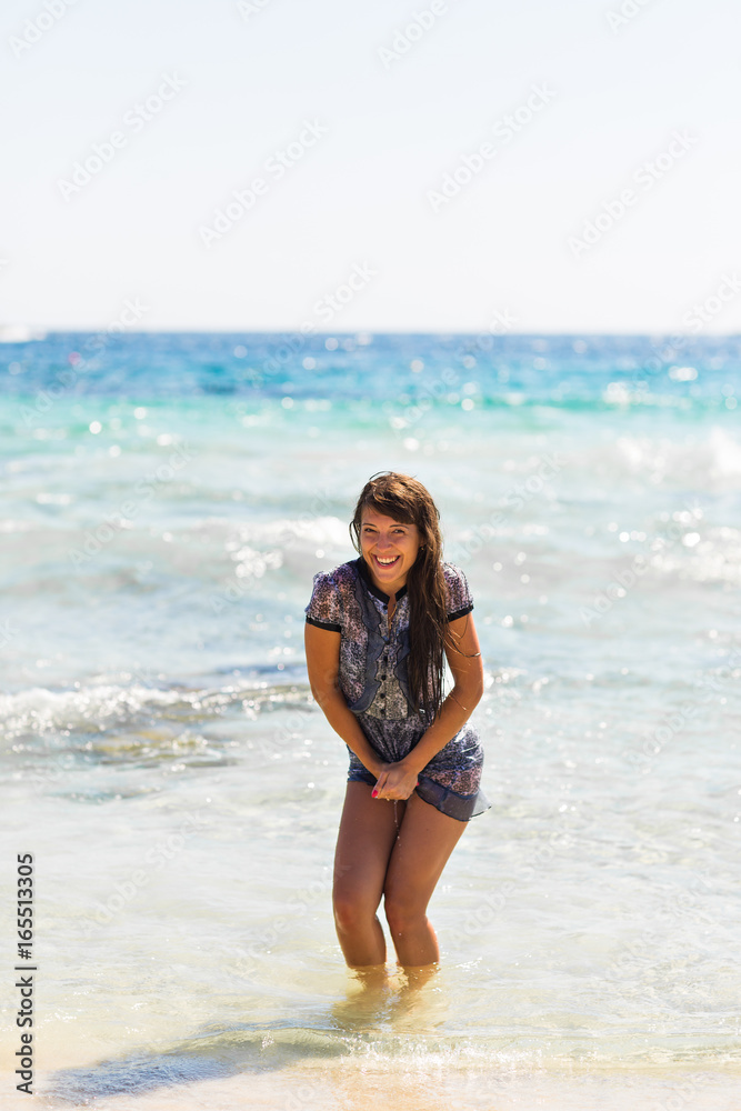 Sexy summer outdoor style beach sea vacation portrait of hot tanned beautiful sporty girl in tunic Sexy summer outdoor style beach sea vacation portrait of hot tanned beautiful sporty girl in tunic