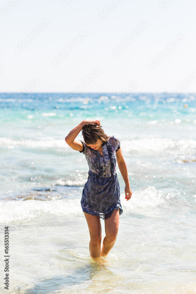 Sexy summer outdoor style beach sea vacation portrait of hot tanned beautiful sporty girl in tunic Sexy summer outdoor style beach sea vacation portrait of hot tanned beautiful sporty girl in tunic
