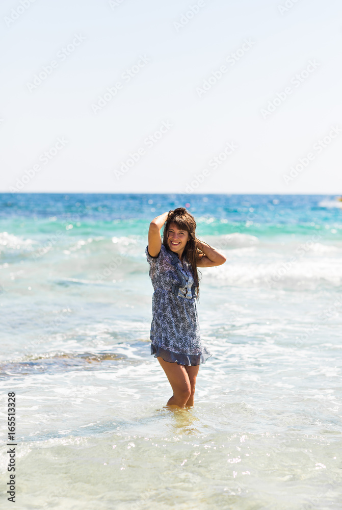 Sexy summer outdoor style beach sea vacation portrait of hot tanned beautiful sporty girl in tunic Sexy summer outdoor style beach sea vacation portrait of hot tanned beautiful sporty girl in tunic