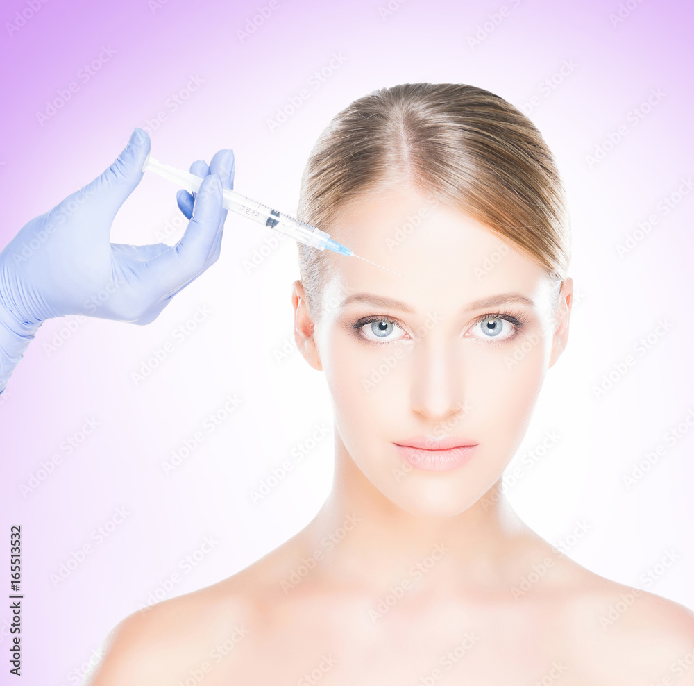 Young, beautiful and healthy woman having skin injections over magenta background. Plastic surgery concept. Young, beautiful and healthy woman having skin injections over magenta background. Plastic surgery concept.