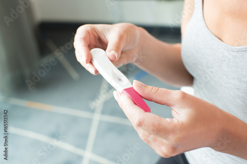 Woman looking at a pregnancy test