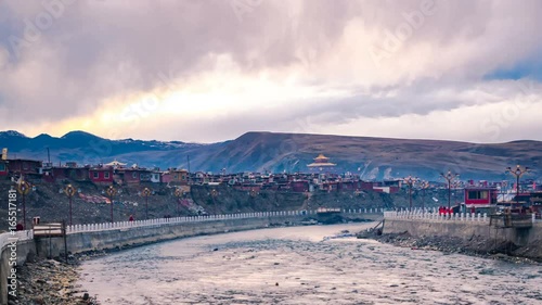 Timelapse of clouds and river in the evening at Yarchen Gar Monastery in Sichuan, China photo