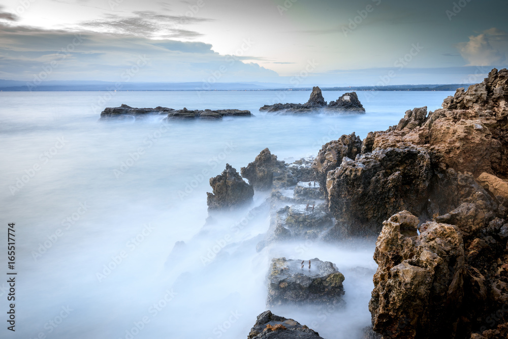 Long exposure image of a rocky beach in Anilao