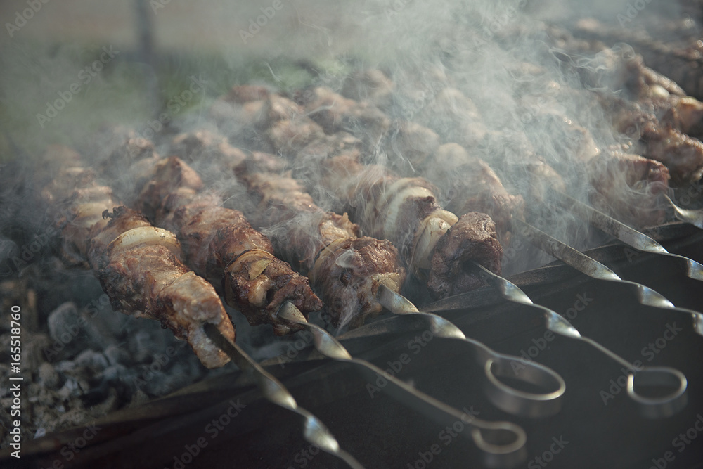Pieces of meat on skewers in a shish kebab roasting on the grill. Pieces of meat on skewers in a shish kebab roasting on the grill.