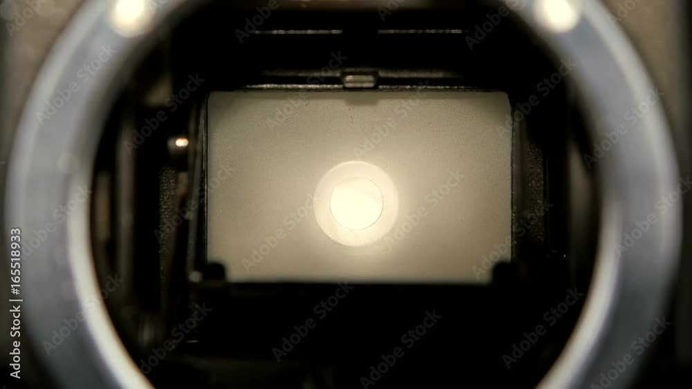 Diaphragm camera shutter blade in slow motion. Closeup camera lens