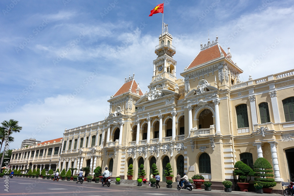 Ho Chi Minh City, Viet Nam - July 11, 2017: The Ho Chi Minh City Hall, or Ho Chi Minh City People's Committee in sunny day, built in 1902-1908 in a French colonial style for the then city of Saigon