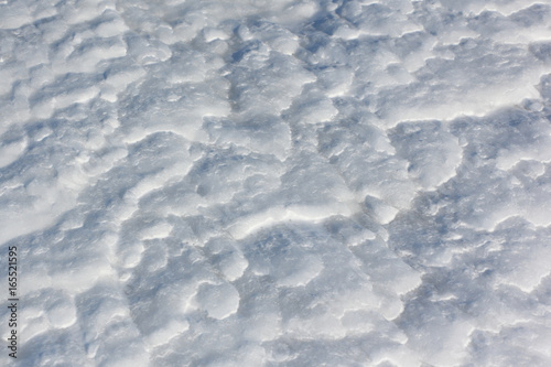 Snow background on a frozen river surface in the winter