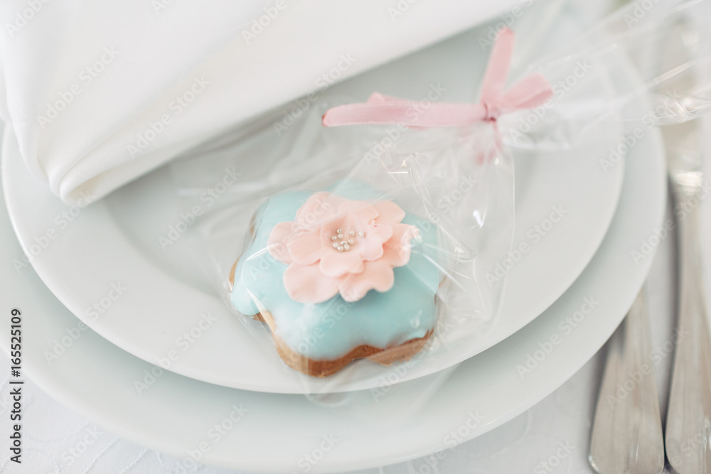 The packaging with cookie stands on the plate The packaging with cookie stands on the plate