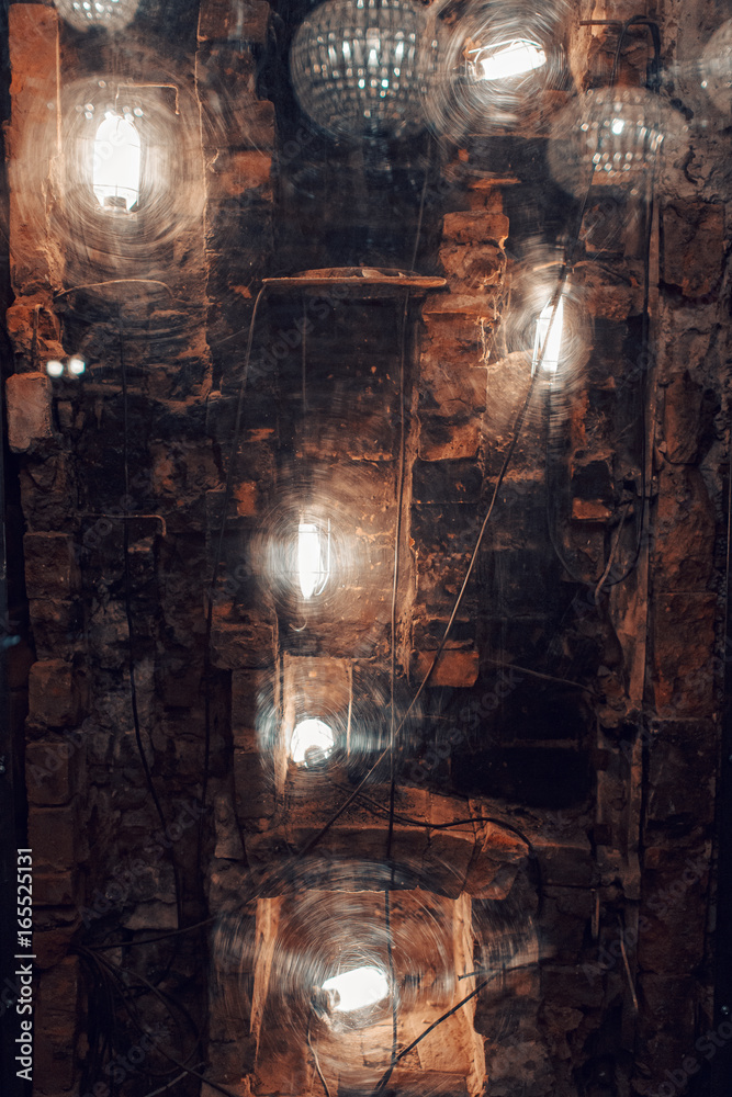 Naklejka brick and lights behind a plastic window. the decor of the nightclub or restaurant in a loft style