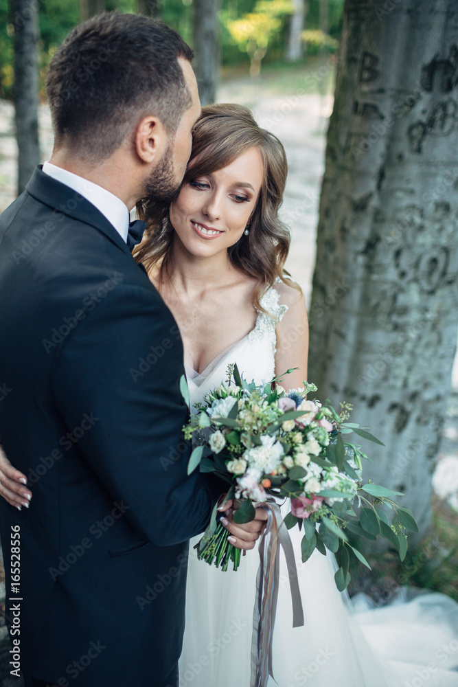 Stunning wedding couple poses in the forest Stunning wedding couple poses in the forest