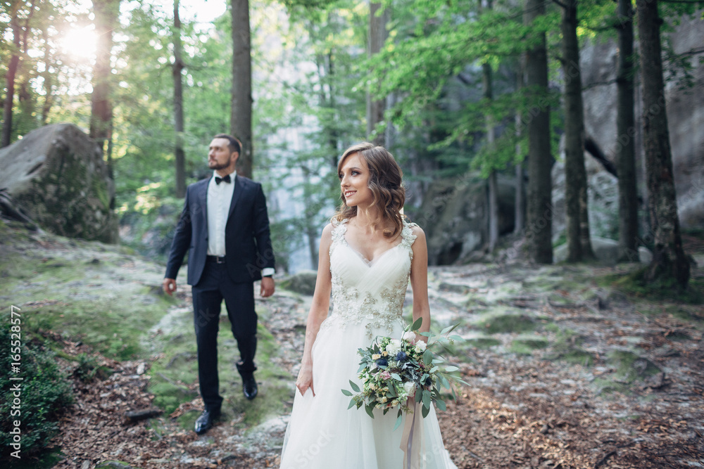 Stunning wedding couple poses in the forest Stunning wedding couple poses in the forest