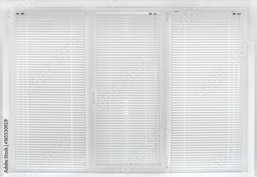 Windows with white venetian blinds.