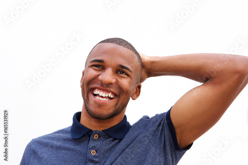 African american man laughing and looking away on white background
