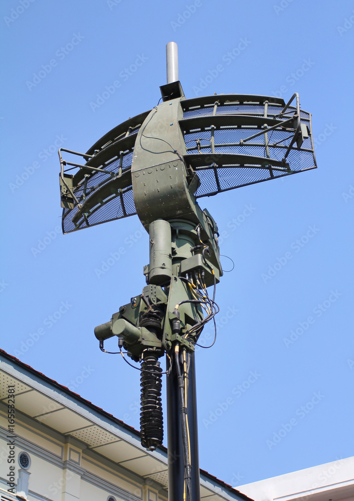 Military radar dish against blue sky background. Military radar dish against blue sky background.