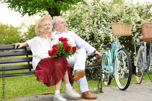 Happy senior couple sitting...