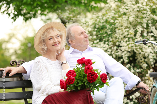 Happy senior couple sitting...