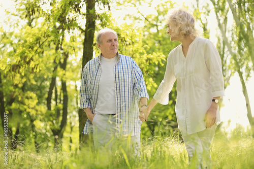 Happy senior couple walking...