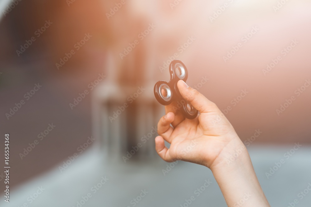 Little child boy playing with fidget spinner outdoors Little child boy playing with fidget spinner outdoors