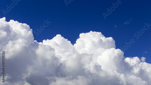 a big and fluffy cumulonimbus cloud in the blue sky