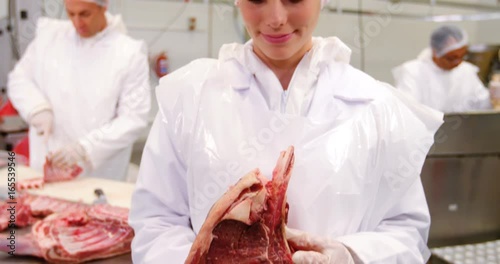 Wallpaper Mural Portrait of female butcher holding raw meat Torontodigital.ca