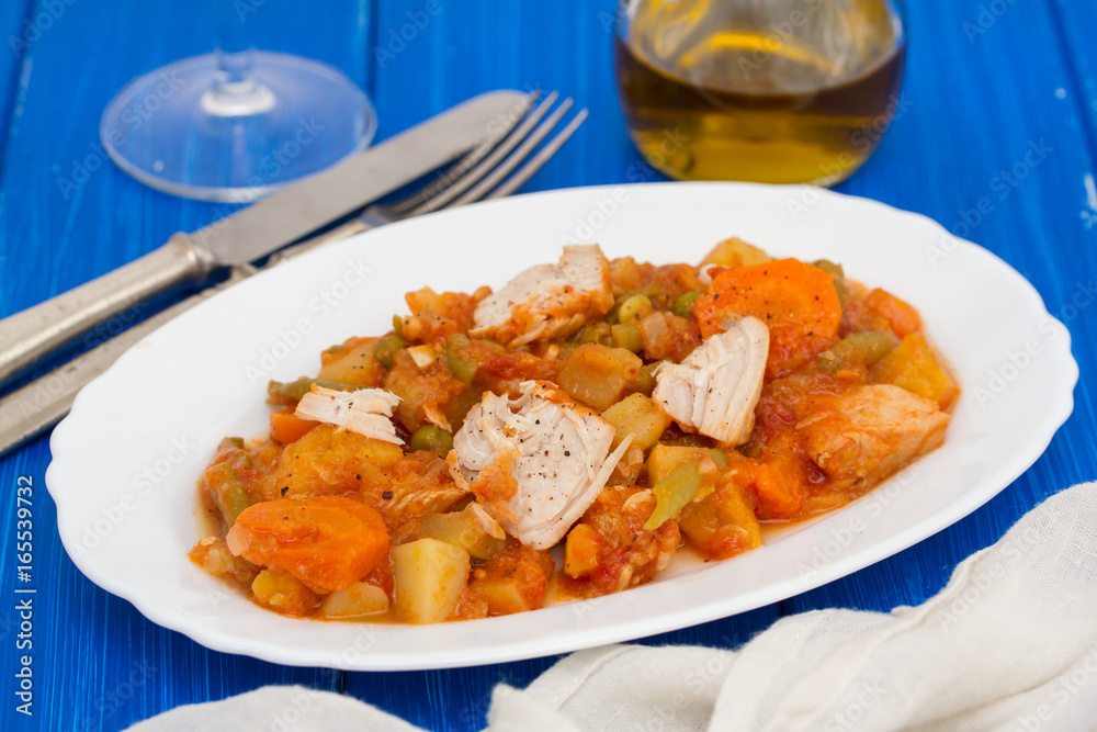 turkey stew with vegetables on white dish on wooden background turkey stew with vegetables on white dish on wooden background