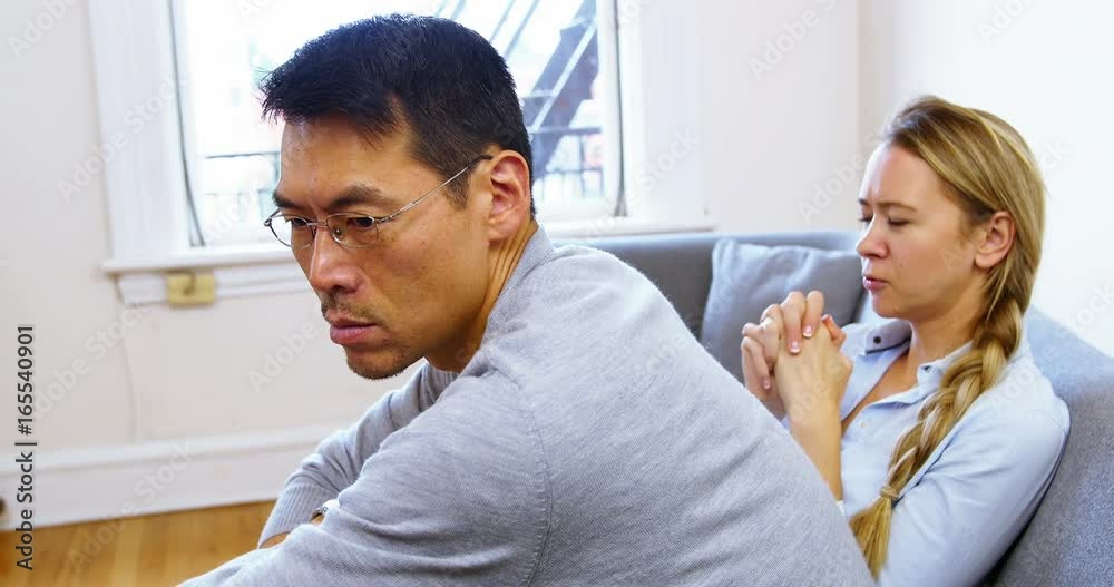 Man and woman upset with each other in living room Man and woman upset with each other in living room