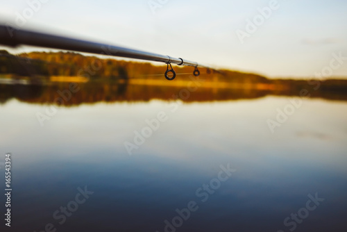 Abstract view of fishing, lake in background, summer sunset
