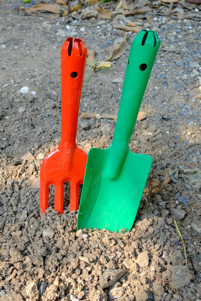 Garden hand fork and shovel stabs on the ground Garden hand fork and shovel stabs on the ground